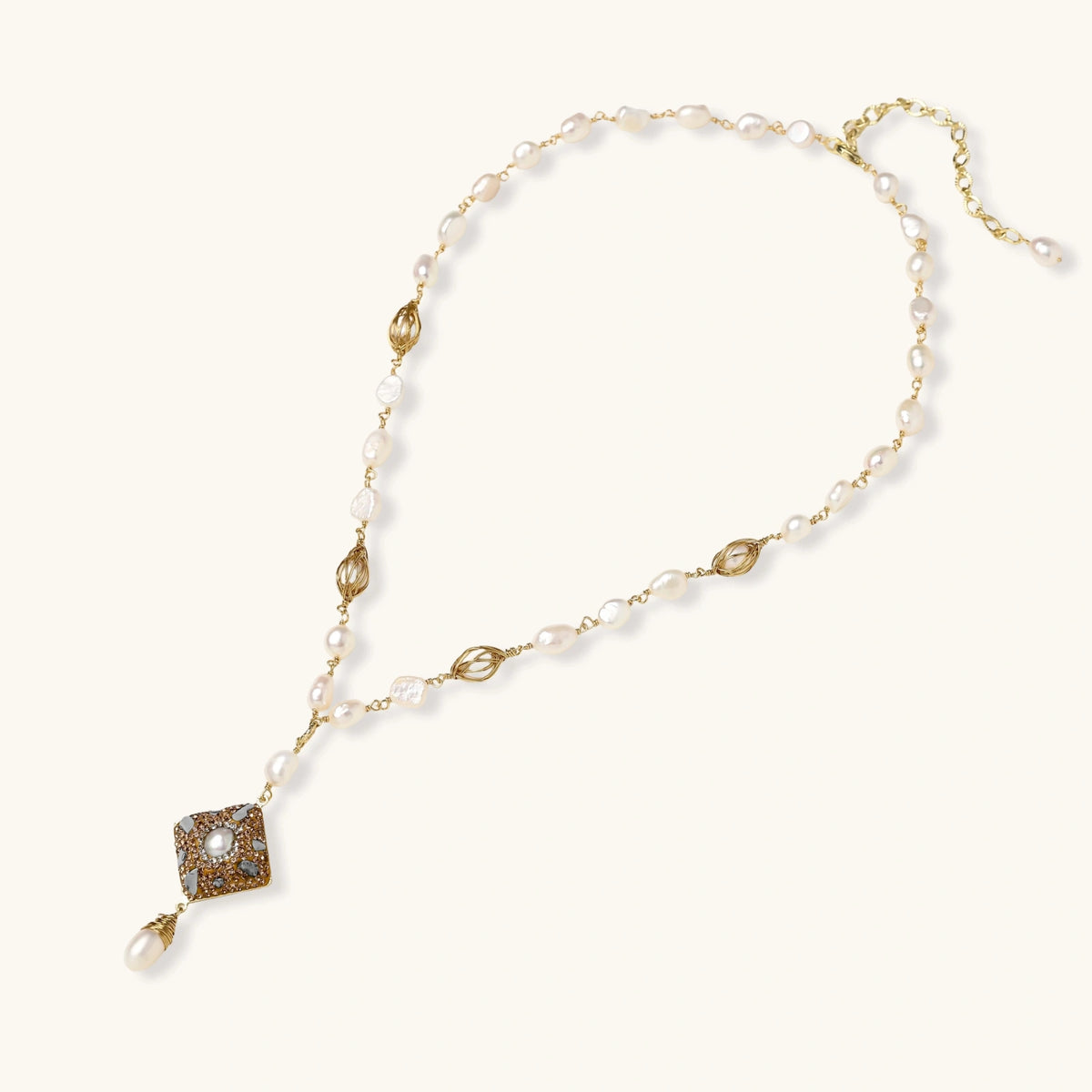 Y-shaped necklace with freshwater pearls, gold filigree stations, and ornate diamond-shaped centerpiece with pearl drop