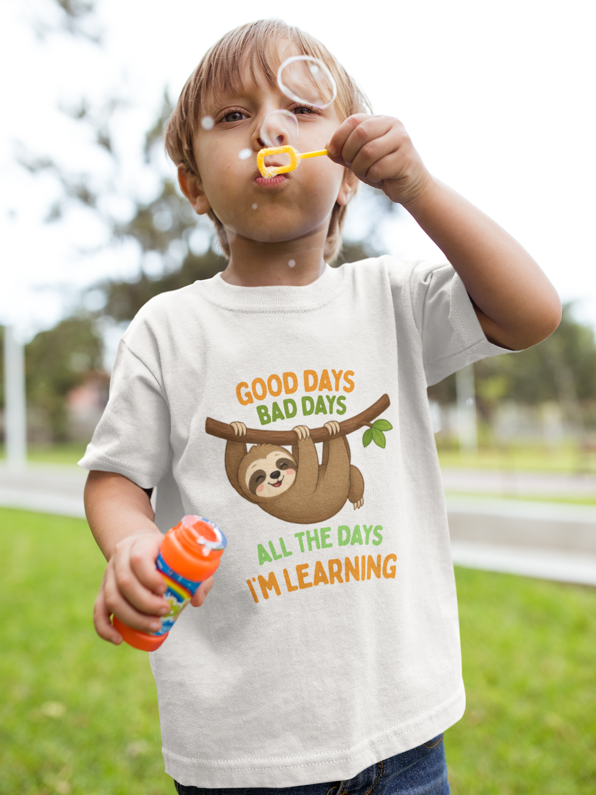 Mini Learning Sloth Tee White - boy blowing bubbles