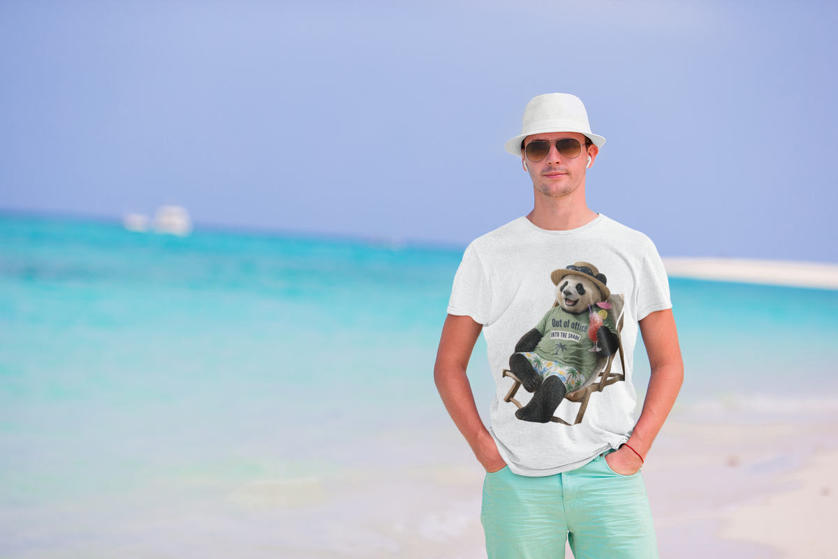 Man on a beach wearing a black graphic tee featuring a panda relaxing in a deck chair with a drink.