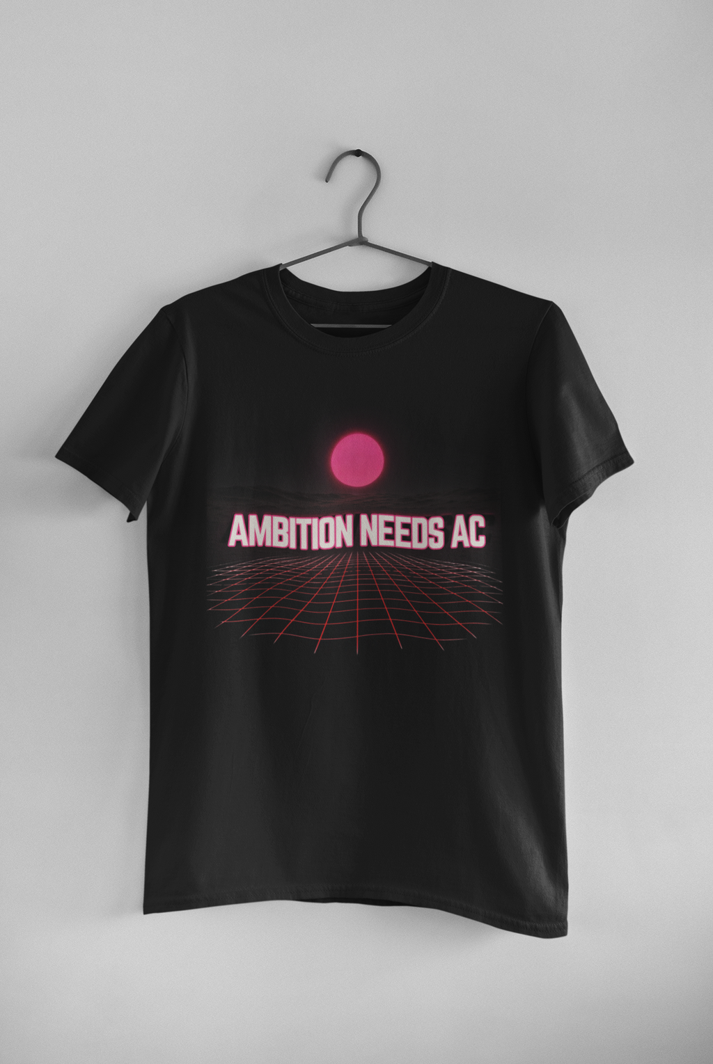 Ambition Needs AC black unisex tee hanging on wall