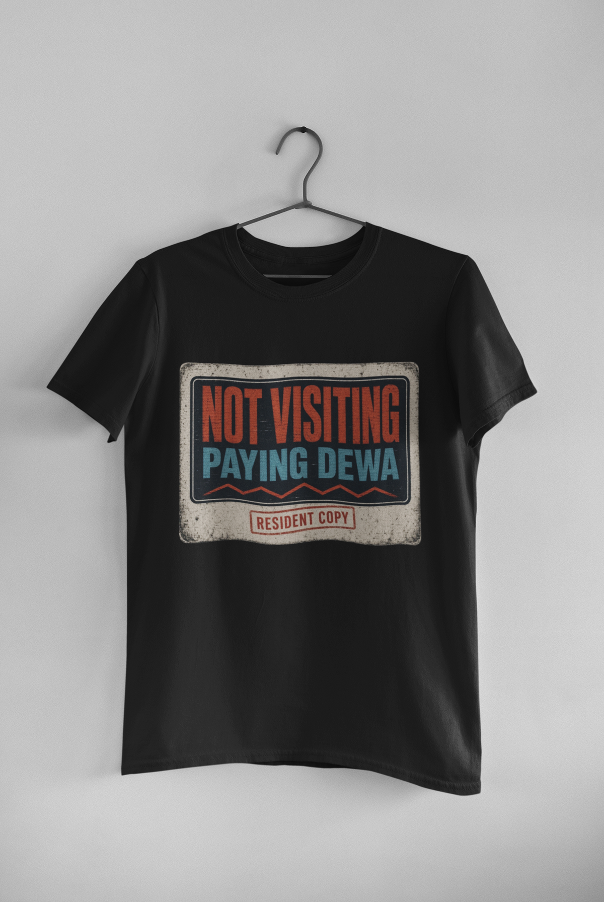 Not Visiting Paying DEWA white unisex tee hanging on wall
