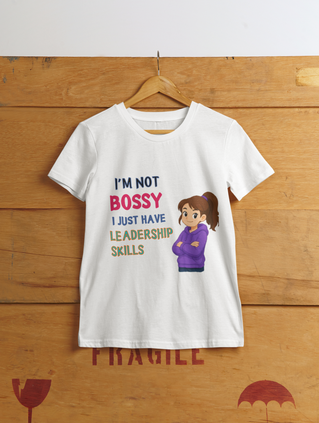Not Bossy Leadership Tee White - hanging on wooden cargo box