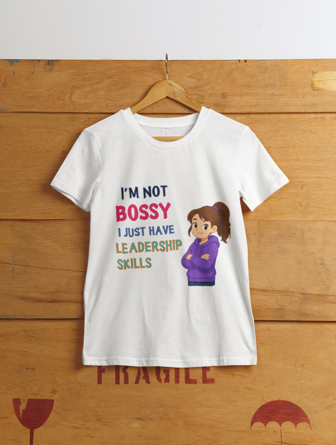 Not Bossy Leadership Tee White - hanging on wooden cargo box