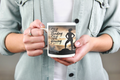 Still Standing Still Glowing - White mug held by woman in denim jacket