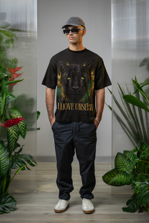 I Move Unseen - Man in oversized black tee with plants