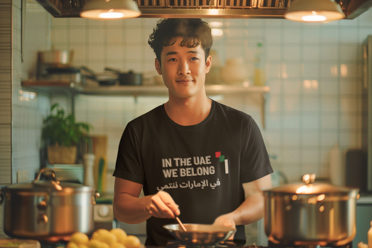 In the UAE We Belong black tee man cooking kitchen mockup